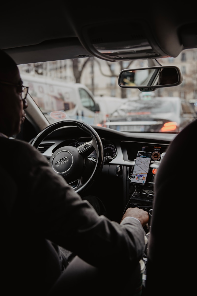 Photo by Thibault Penin À propos de Code challenge - man in black jacket driving car during daytime